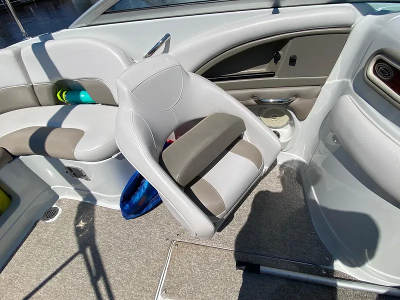 Slide: The Image of 2015 Crownline Eclipse E2 boat interior with gray seating and carpeted floor. - 12