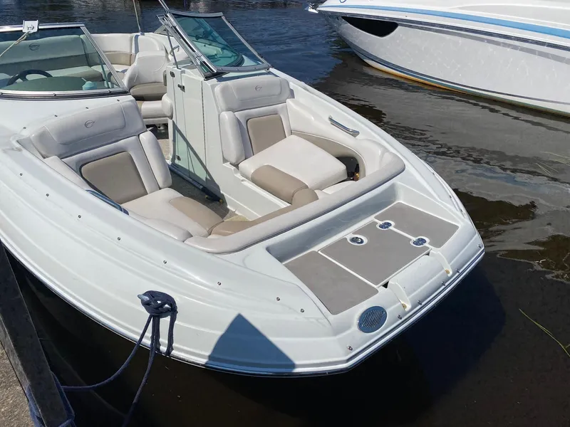 Slide: The Image of 2015 Crownline Eclipse E2 boat docked, featuring spacious seating and sleek design. - 4