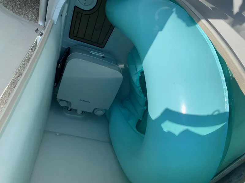 Slide: The Image of 2015 Crownline Eclipse E2 boat storage with portable toilet and inflatable tube. - 8
