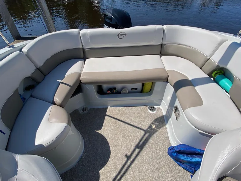 Slide: The Image of 2015 Crownline Eclipse E2 boat interior with cushioned seating and storage compartments. - 9
