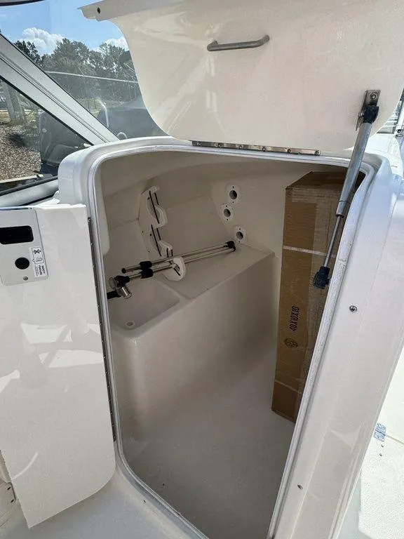 Slide: The Image of 2025 Key West 239 DFS boat storage compartment with open hatch. - 18