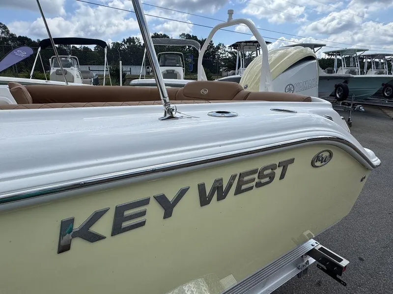 Slide: The Image of 2025 Key West 239 DFS boat, side view with logo, parked outdoors. - 3