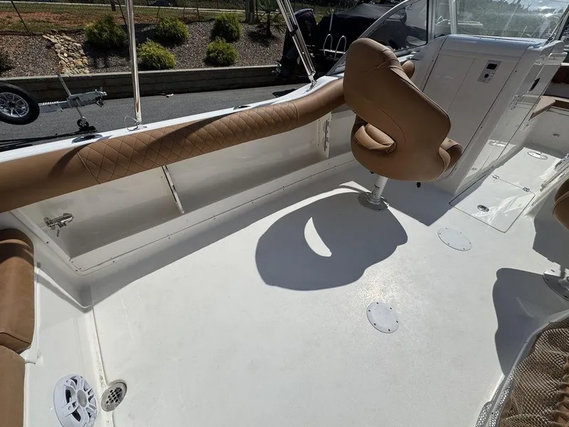 Slide: The Image of 2025 Key West 239 DFS boat interior with tan seating and white deck. - 6