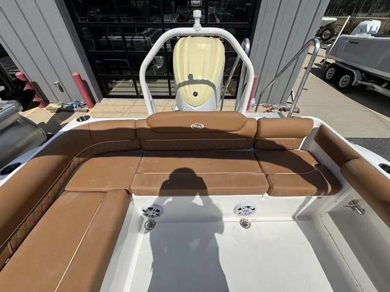 Slide: The Image of 2025 Key West 239 DFS boat interior with brown seating and white deck. - 8