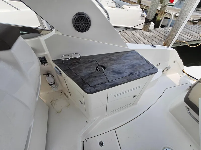 Slide: The Image of 2014 Sea Ray 350 Sundancer boat interior with sleek countertop and storage. - 10