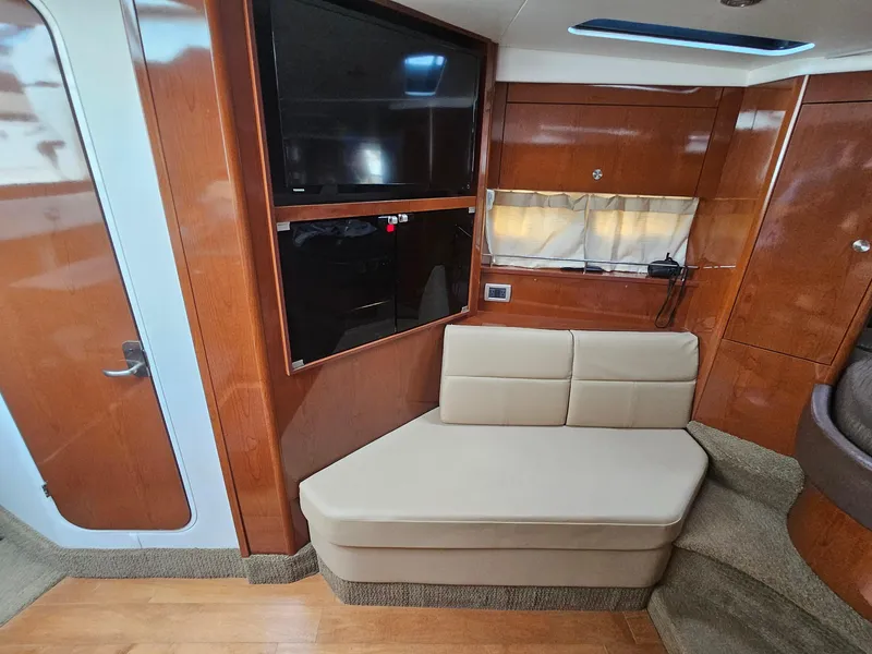 Slide: The Image of Interior of 2014 Sea Ray 350 Sundancer with TV and beige seating. - 15