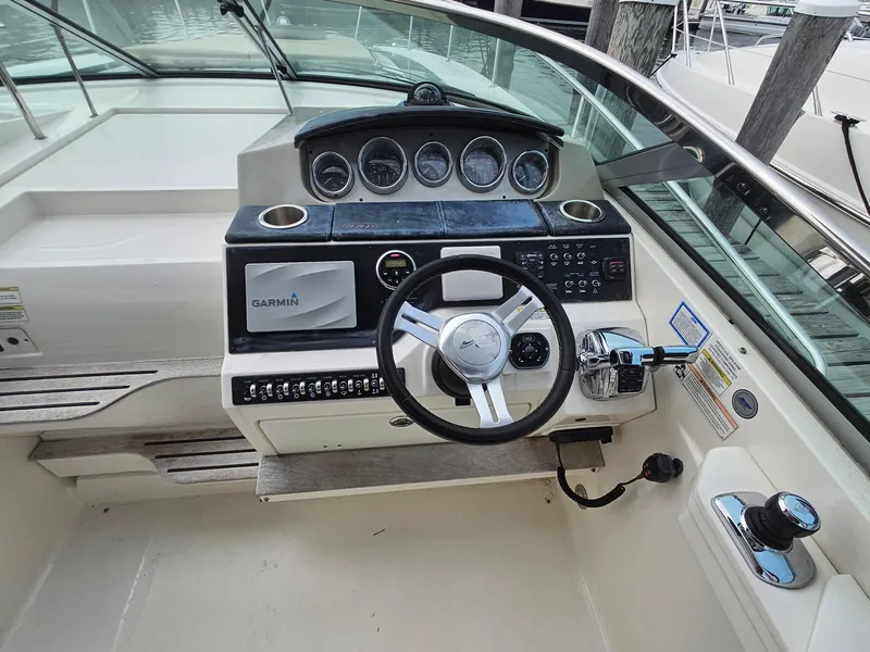 Slide: The Image of 2014 Sea Ray 350 Sundancer helm with Garmin navigation and modern controls. - 5