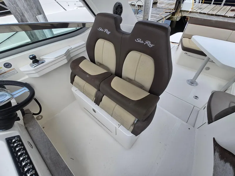 Slide: The Image of 2014 Sea Ray 350 Sundancer cockpit with dual helm seats and steering wheel. - 7