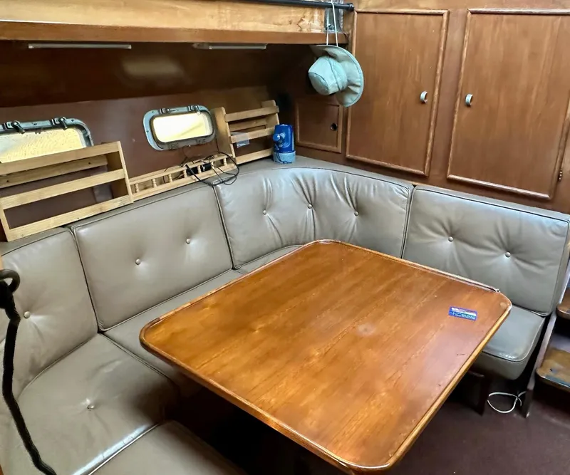 Slide: The Image of Interior of 1986 Cytra Bavaria 40 yacht with wooden table and cushioned seating. - 10