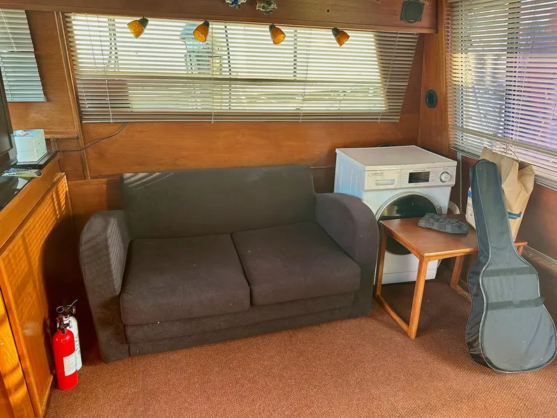 Slide: The Image of Interior of 1986 Cytra Bavaria 40 with sofa, washing machine, and guitar case. - 11