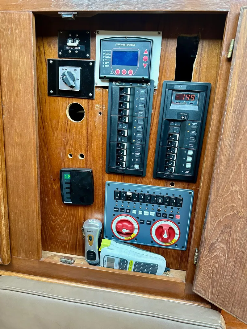 Slide: The Image of Electrical control panel inside a 1986 Cytra Bavaria 40 boat, featuring switches and meters. - 12
