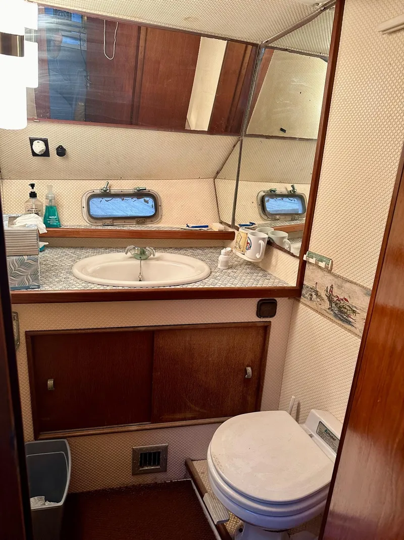 Slide: The Image of Bathroom interior of 1986 Cytra Bavaria 40 yacht with sink, mirror, and toilet. - 14