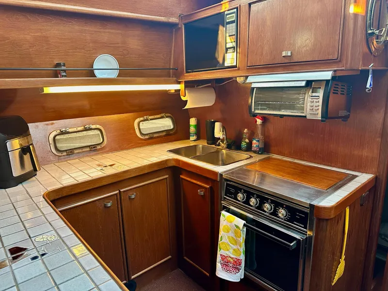 Slide: The Image of Cozy kitchen in 1986 Cytra Bavaria 40 yacht with wooden cabinets and modern appliances. - 15