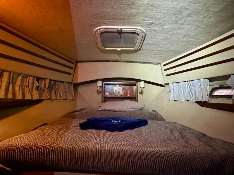 Slide: The Image of Cozy cabin interior of 1986 Cytra Bavaria 40 yacht with bed and porthole. - 16
