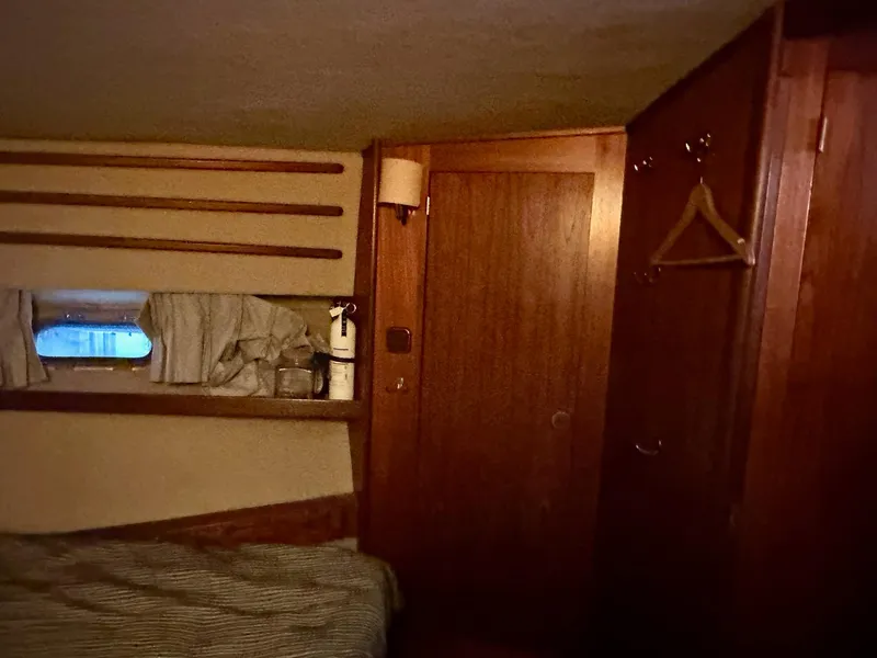 Slide: The Image of Cozy cabin interior of 1986 Cytra Bavaria 40 yacht with wooden paneling and small window. - 17