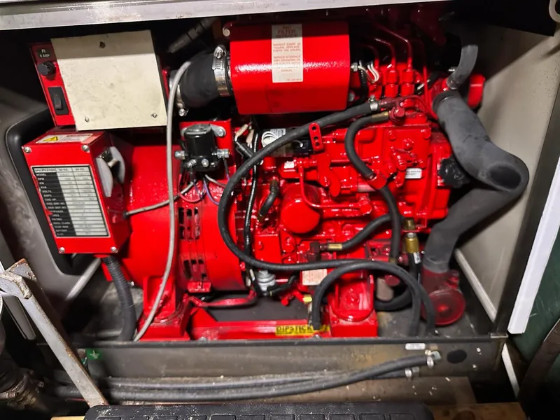 Slide: The Image of Engine compartment of a 1986 Cytra Bavaria 40, featuring a red marine engine. - 21