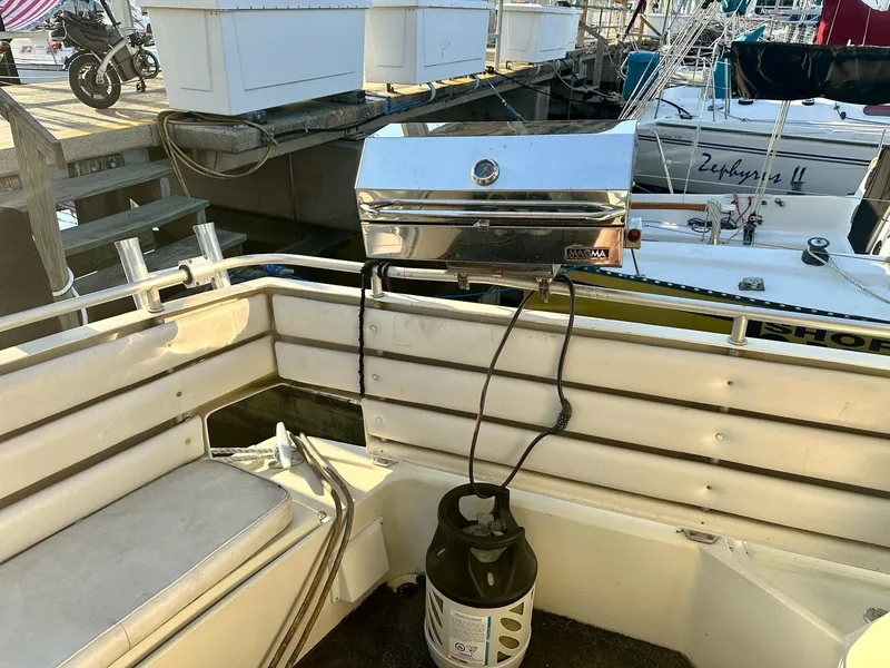 Slide: The Image of Boat deck with a Magma grill and propane tank on a 1986 Cytra Bavaria 40. - 6