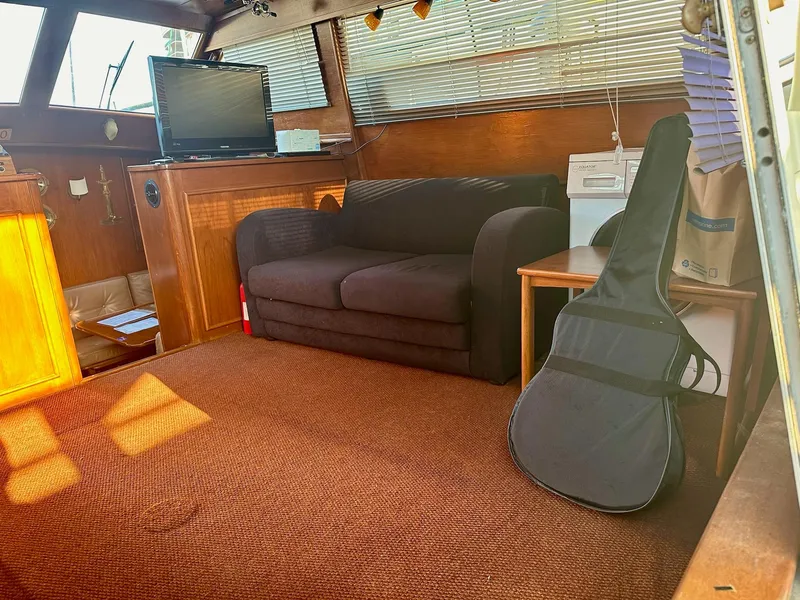 Slide: The Image of Cozy interior of 1986 Cytra Bavaria 40 with sofa, TV, and guitar case. - 9