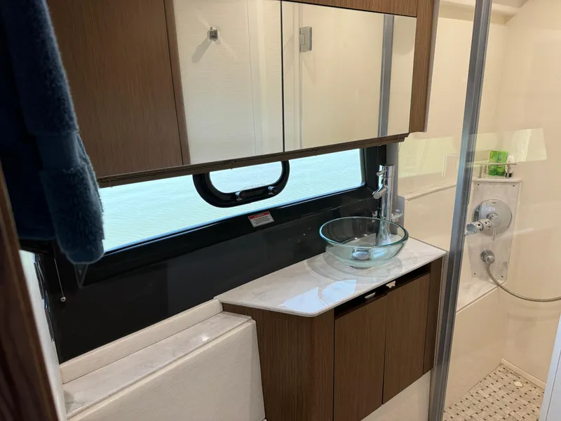Slide: The Image of Luxurious bathroom in 2017 Sea Ray Sundancer 460 yacht with modern fixtures and glass sink. - 18