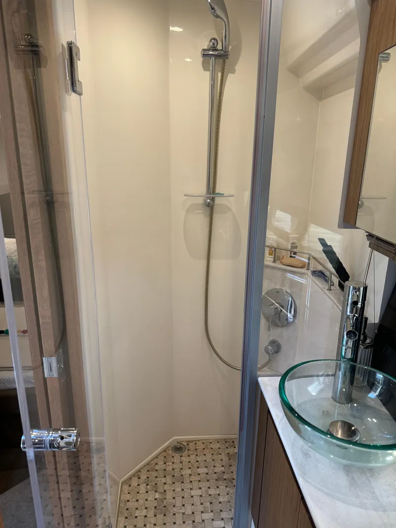 Slide: The Image of 2017 Sea Ray Sundancer 460 yacht bathroom with modern shower and glass sink. - 20