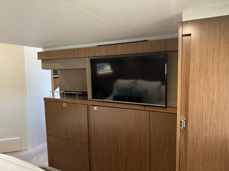 Slide: The Image of Interior of 2017 Sea Ray Sundancer 460 with wooden cabinetry and built-in TV. - 23