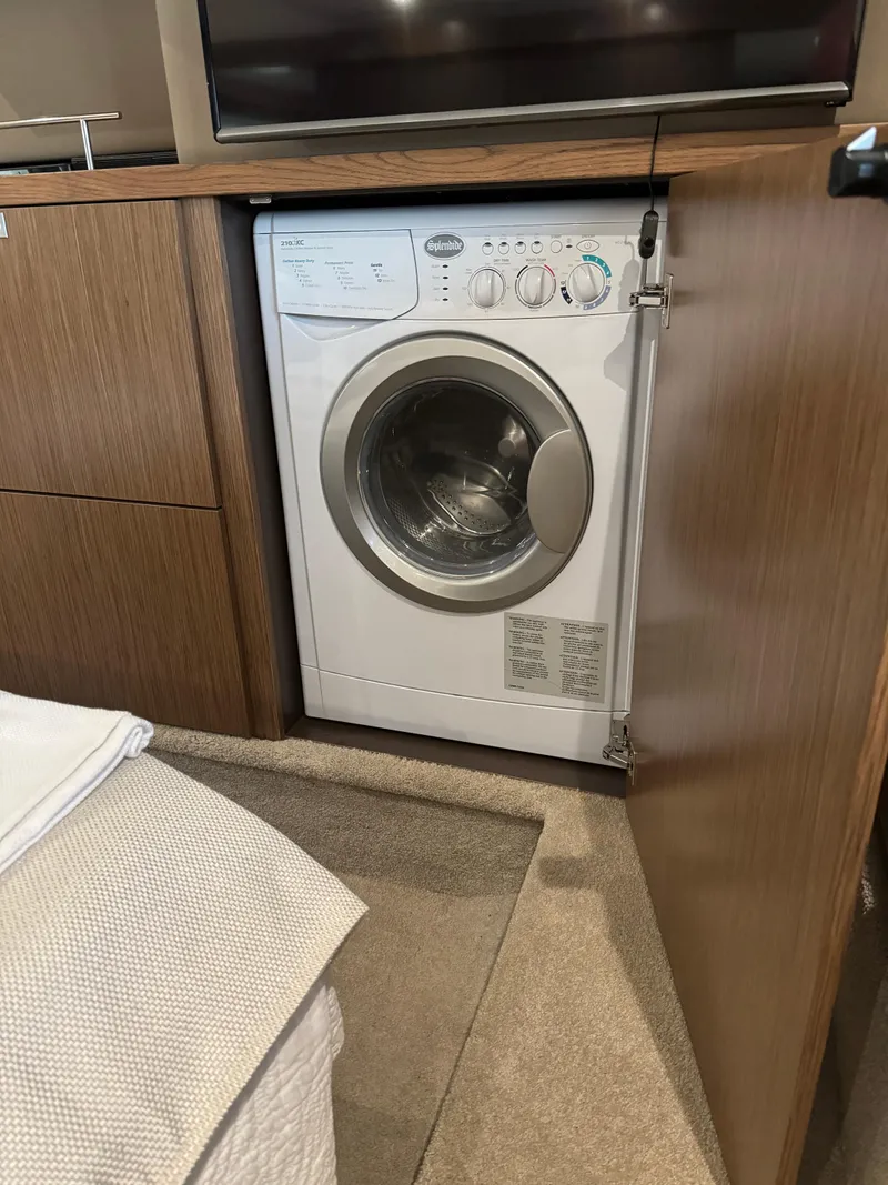 Slide: The Image of Washing machine inside 2017 Sea Ray Sundancer 460 yacht's wooden cabinet. - 24