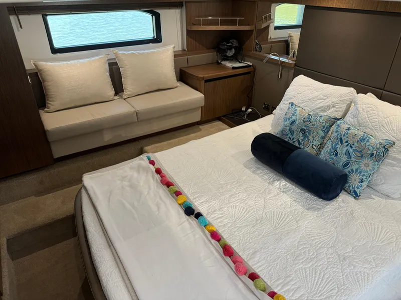 Slide: The Image of Luxurious 2017 Sea Ray Sundancer 460 cabin with elegant bedding and cozy seating area. - 26
