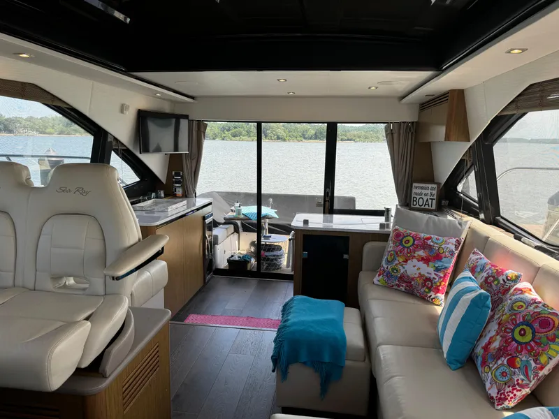 Slide: The Image of Luxurious 2017 Sea Ray Sundancer 460 yacht interior with vibrant decor and scenic water view. - 29