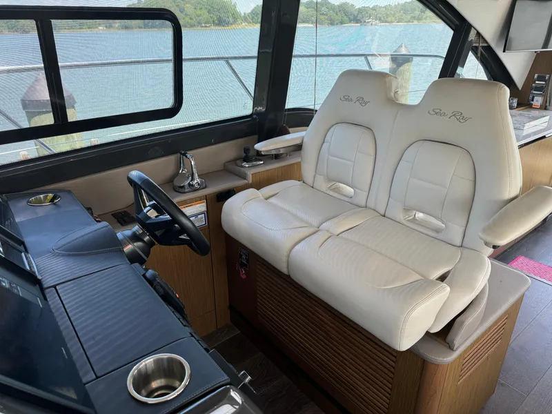 Slide: The Image of 2017 Sea Ray Sundancer 460 interior with plush seating and scenic water view. - 30