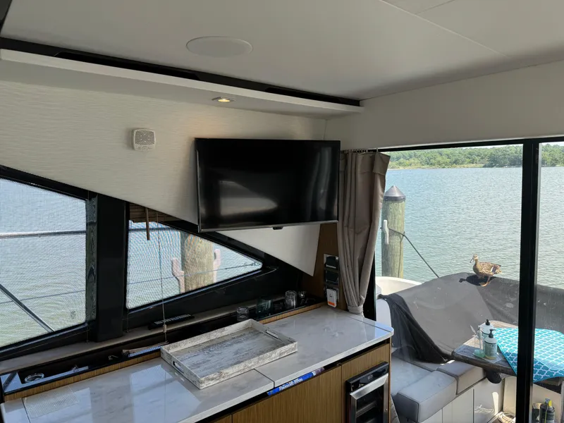 Slide: The Image of Interior of 2017 Sea Ray Sundancer 460 yacht with TV and waterfront view. - 33
