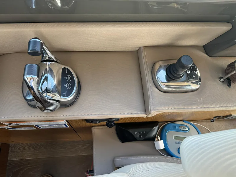 Slide: The Image of Control panel of a 2017 Sea Ray Sundancer 460 yacht with throttle and joystick. - 34