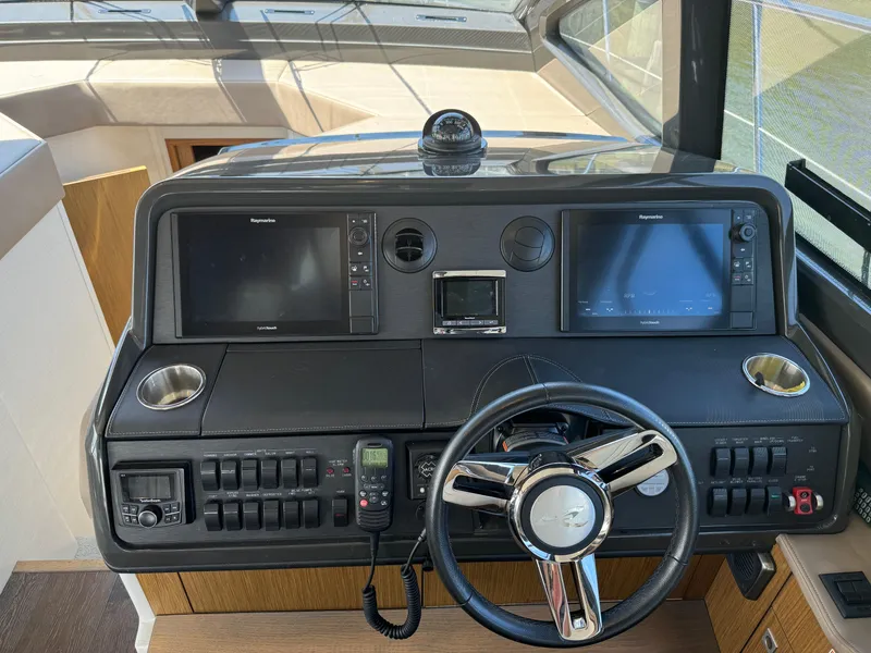 Slide: The Image of 2017 Sea Ray Sundancer 460 helm with modern navigation controls and steering wheel. - 39