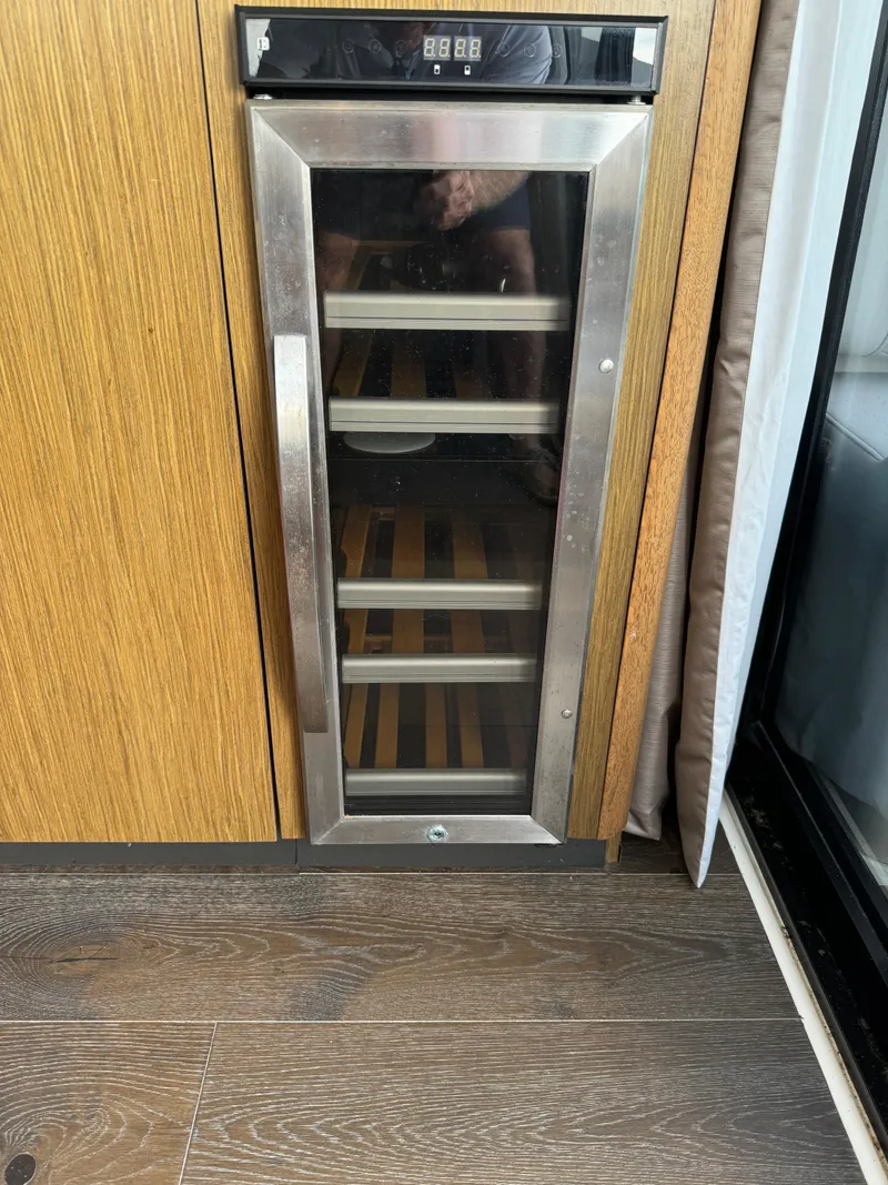 Slide: The Image of Wine cooler in 2017 Sea Ray Sundancer 460 yacht interior, featuring wooden flooring. - 44