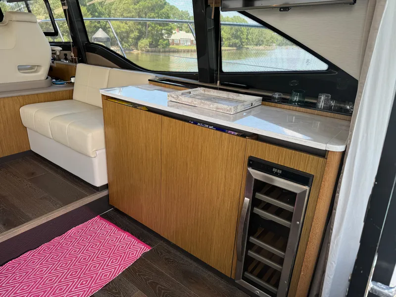 Slide: The Image of Interior of 2017 Sea Ray Sundancer 460 yacht with seating and mini fridge. - 46