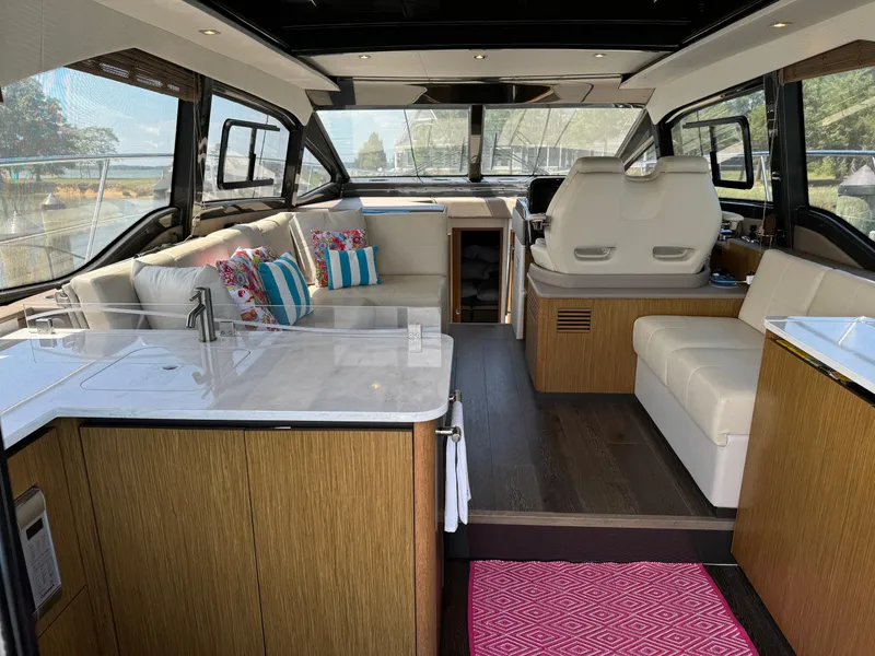 Slide: The Image of Interior of 2017 Sea Ray Sundancer 460 yacht with modern seating and kitchen area. - 47