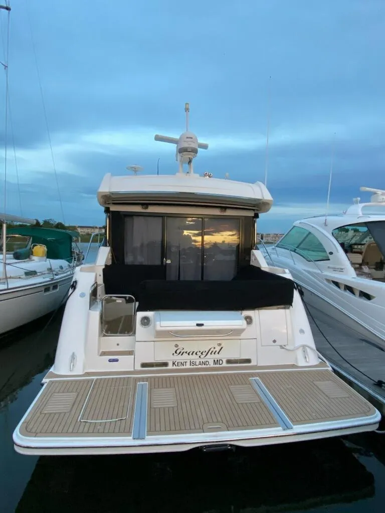 Slide: The Image of 2017 Sea Ray Sundancer 460 docked at sunset, rear view. - 48