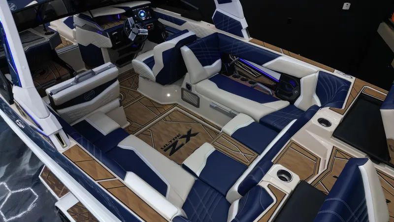Slide: The Image of Luxurious interior of 2024 Tigé Ultré 23ZX boat with blue and white seating. - 13