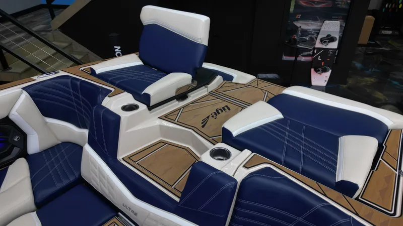 Slide: The Image of 2024 Tigé Ultré 23ZX boat interior with blue and white seating and wood accents. - 16