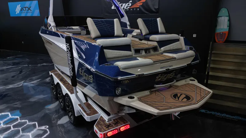 Slide: The Image of 2024 Tigé Ultré 23ZX boat on trailer, showcasing sleek design and luxury seating. - 20