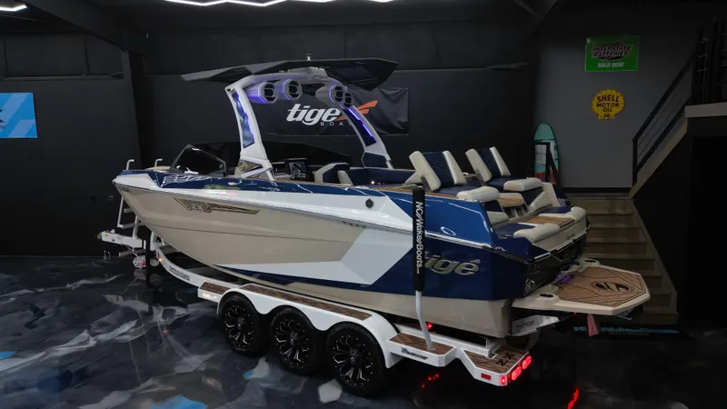Slide: The Image of 2024 Tigé Ultré 23ZX boat in showroom, featuring sleek design and modern amenities. - 5