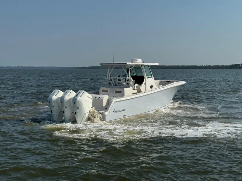 Slide: The Image of 2024 Sailfish 360 CC boat cruising on open water. - 12