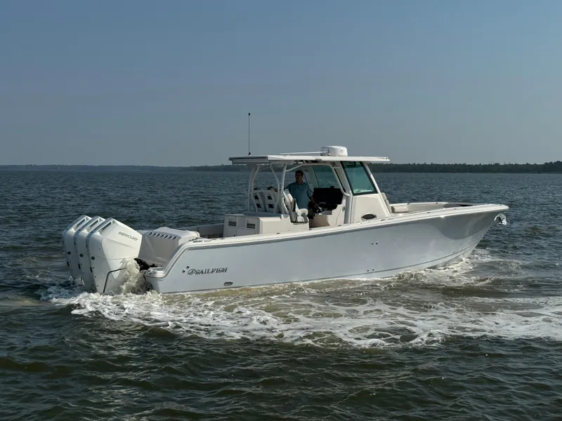 Slide: The Image of 2024 Sailfish 360 CC boat cruising on open water. - 14