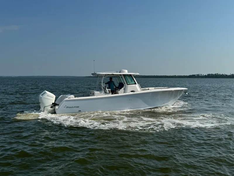 Slide: The Image of 2024 Sailfish 360 CC boat cruising on open water. - 15