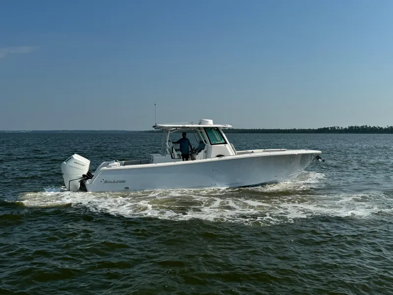 Slide: The Image of 2024 Sailfish 360 CC boat cruising on open water. - 16