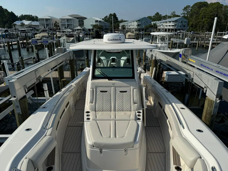 Slide: The Image of 2024 Sailfish 360 CC boat docked at marina with Garmin equipment. - 19
