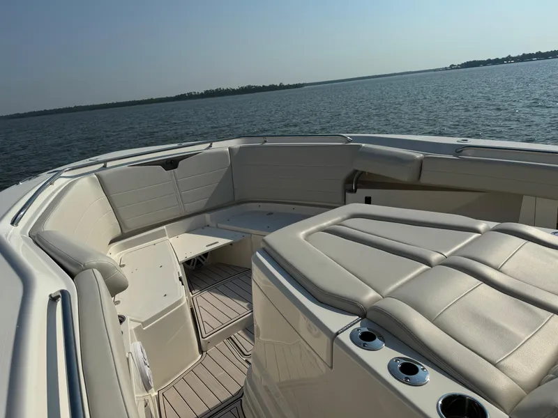 Slide: The Image of 2024 Sailfish 360 CC boat interior with cushioned seating, ocean view. - 20