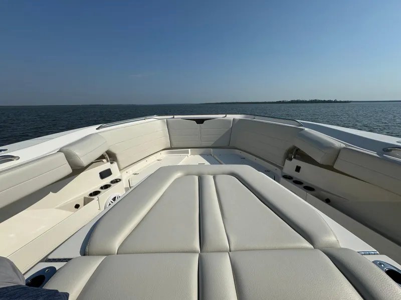 Slide: The Image of 2024 Sailfish 360 CC boat interior with cushioned seating on open water. - 21