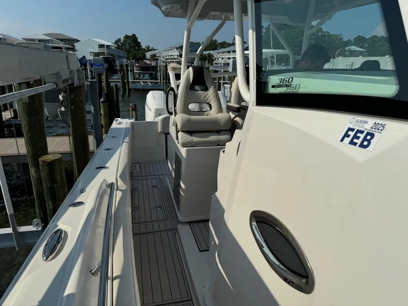 Slide: The Image of 2024 Sailfish 360 CC boat docked, featuring sleek design and comfortable seating. - 23
