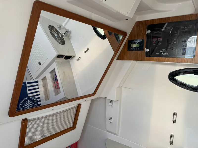 Slide: The Image of Interior of 2024 Sailfish 360 CC boat with mirror and control panel. - 25