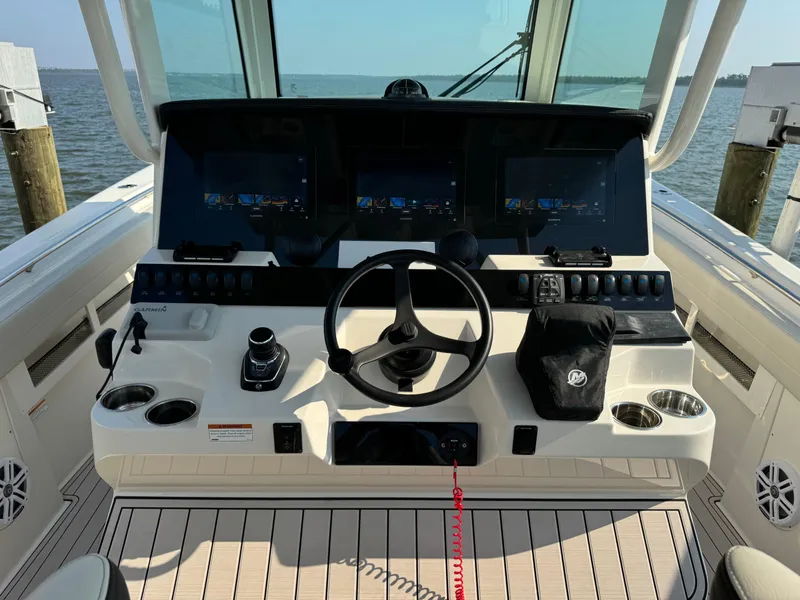Slide: The Image of 2024 Sailfish 360 CC boat helm with advanced navigation displays and controls. - 28